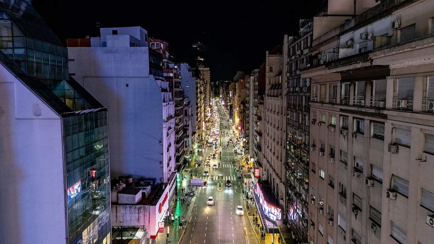 Night aerial view of the junction of Avenida 9 de Julio and Avenida Corrientes in Buenos Aires, with the Obelisk lit