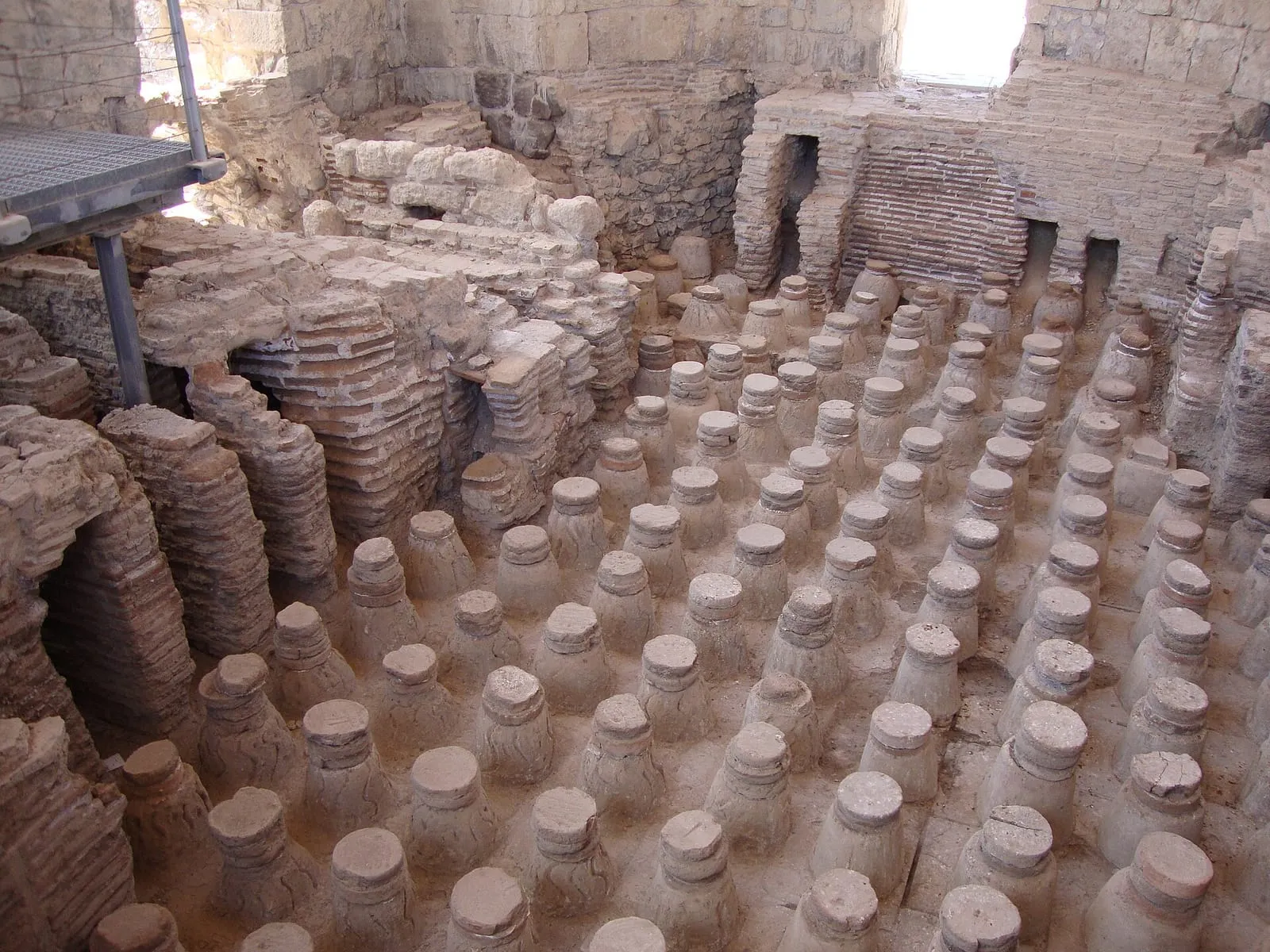 Hypocaust of the Roman baths at Bet She’an, Israel, with dozens of brick pillars under the removed floor