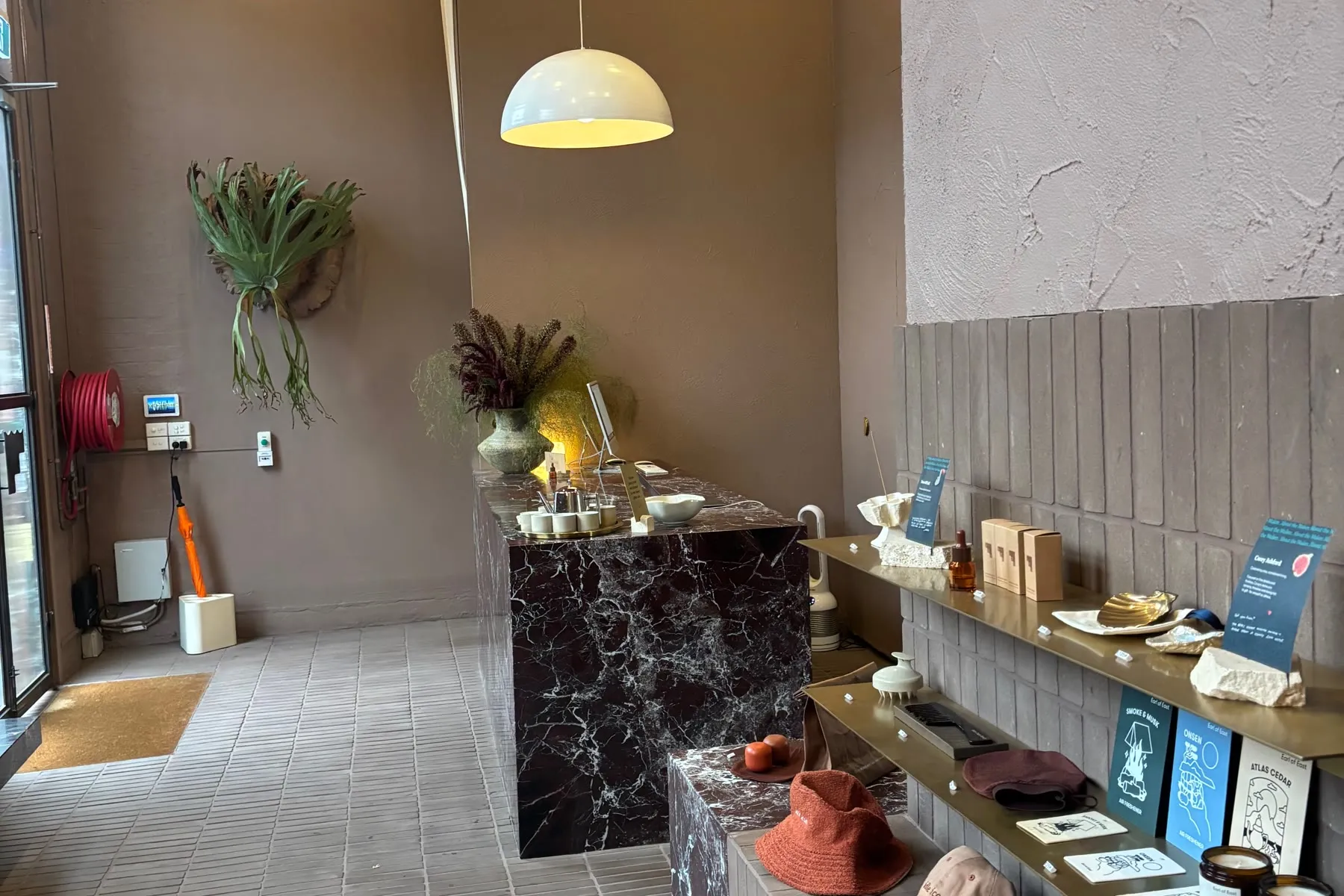 Reception at Sense of Self in Collingwood, with red marble, shelving and textured walls