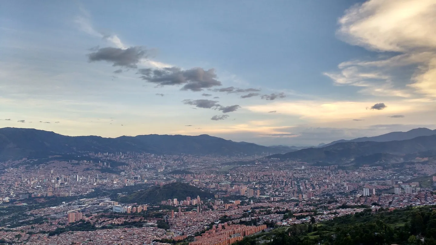 Panoramic view of the Aburrá Valley and Medellín at dusk from Cerro El Picacho, with the mountains all around